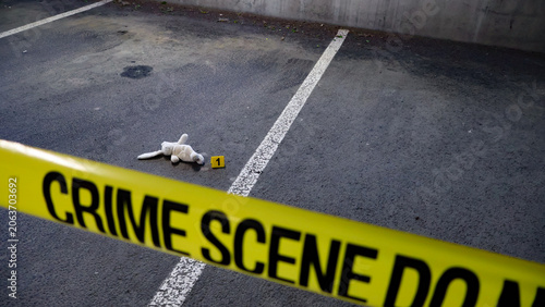 Foto Crime scene tape crosses a parking lot, indicating an investigation with an evid