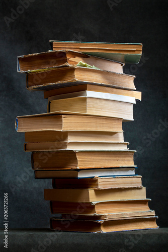 A stack of old books and notebooks on the table