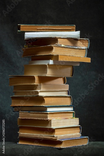 A stack of old books and notebooks on the table