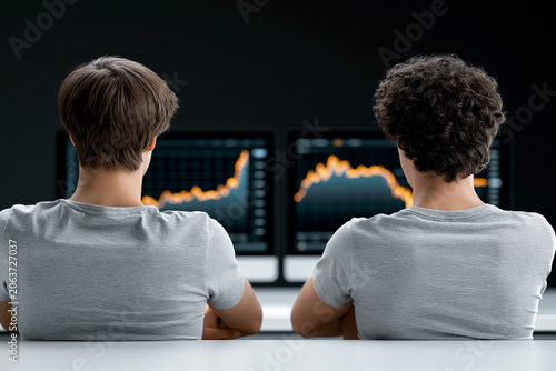 An image capturing the intense volatility of cryptocurrency markets, traders anxiously watching screens, with charts showing rapid spikes and crashes, dramatic lighting