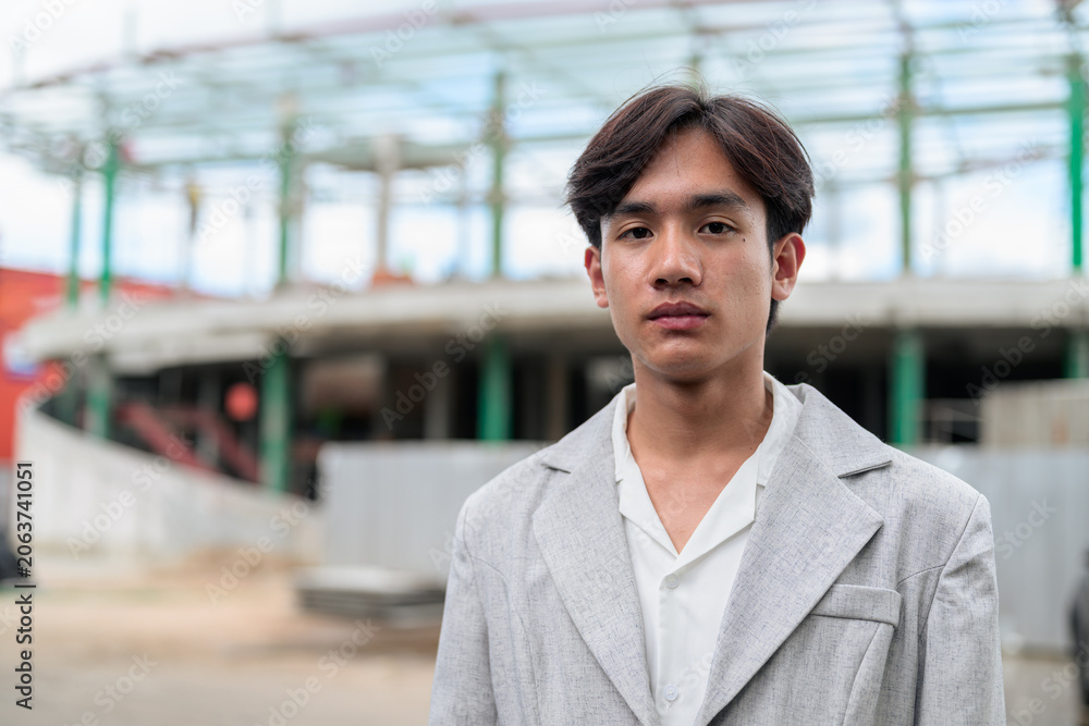 Obraz premium Portrait of non-binary Thai Isan contractor at construction site