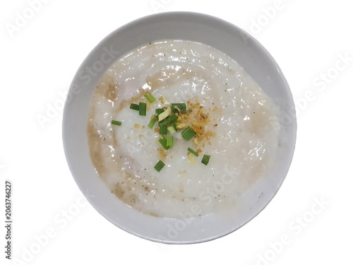 Chinese style minced pork in plain rice porridge topped by black pepper and green onion for breakfast on white background