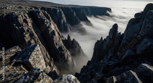 Jagged Rocky Cliffs Emerging From Dense Fog