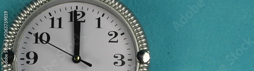 Clock face displaying a moment of critical timing The hour and minute hands point to twelve representing important schedules.