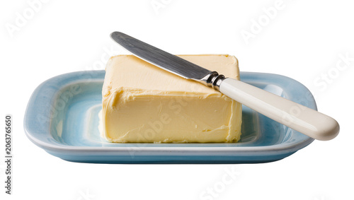 фотографія Yellow butter block on blue dish with knife, isolated on transparent background