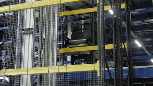 Automated warehouse system with computer controlled lifting transport devices.