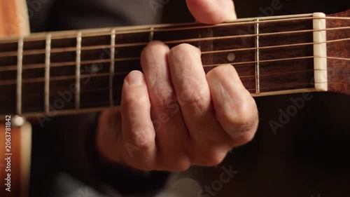 Capturing the Essence of Guitar Playing: A Close-Up on the Hand Positioning and Technique Involved in Strumming and Chording on an Acoustic Guitar