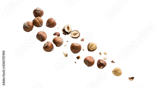 A scattering of whole and cracked hazelnuts with small fragments, isolated on a white background, for culinary and, healthy snack concepts