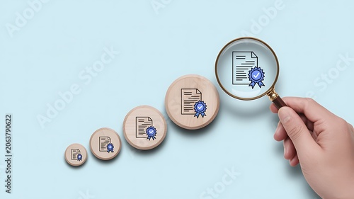 Business growth, success, and analysis concept, magnifying glass examining increasing document icons on wooden circles