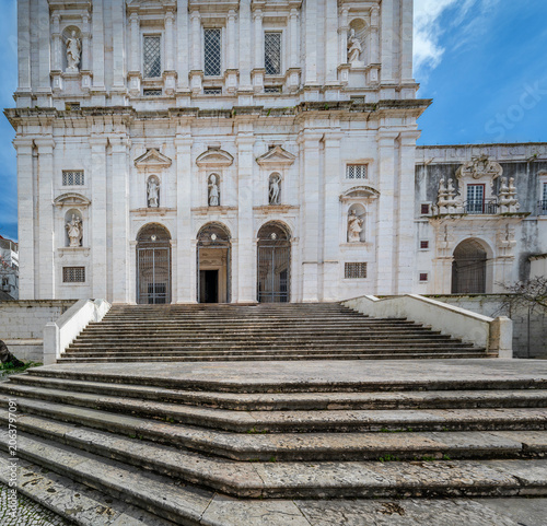 Sao Vicente de Fora Church facade featuring a monumental staircase leading to its ornate entrance with statues, representing historic Portuguese architecture and religious heritage in Lisbon