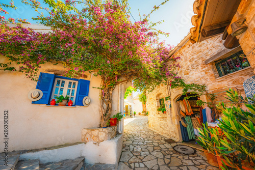 Alley decorated with flowers in the picturesque village of Afionas vacation on the island of Corfu in Greece nearPorto Timoni beach