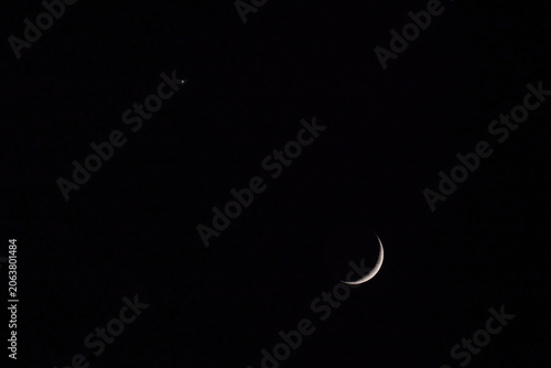 The waxing moon and Venus in the dark night sky