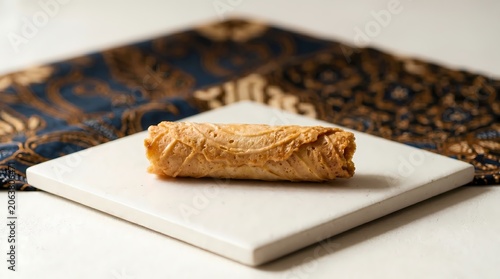 Delicious pastry on a square marble board with decorative fabric