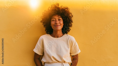 Smiling African American Woman Standing Against Yellow Wall