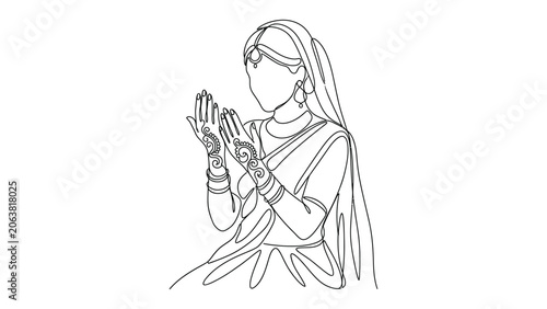 Indian woman in traditional clothing praying.