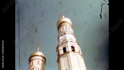 Gleaming golden church domes, ivan great bell tower of assumption cathedral within the moscow kremlin against a clear blue sky. Old film. Archival retro. Vintage archive. 1960s Moscow Russia USSR