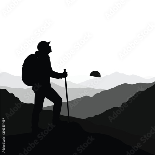 Silhouette of a hiker standing on a mountain peak at sunrise.