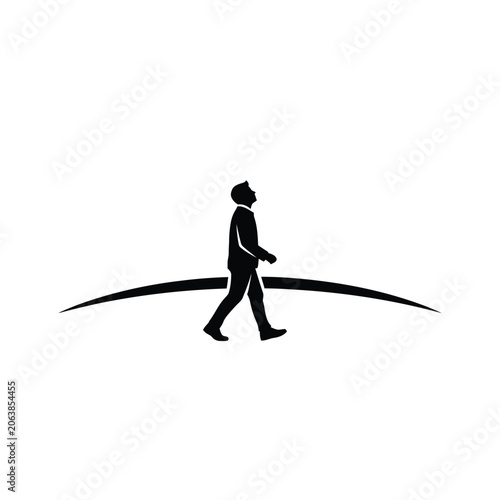 Silhouette of a man walking forward looking up.