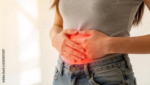 Woman holding her stomach with red glow