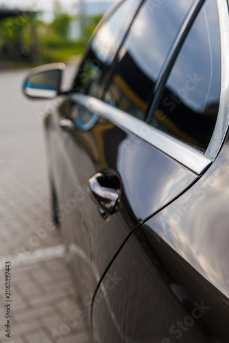 Modern luxury car close up detail of sleek body lines, metallic blue vehicle design with elegant textured elements