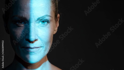 Woman with digital scanning beam passing over her face. Cybernetic identification concept. Biometric authentication with blue light projection on human skin