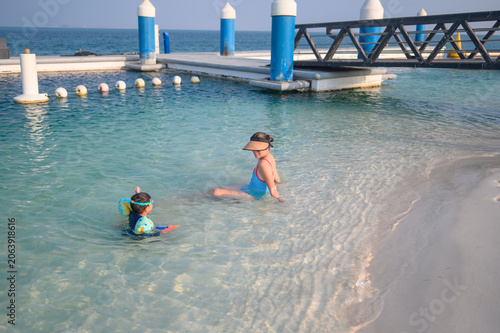 Two Children Playing in Shallow Water at a Beach Resort