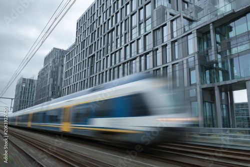A high-speed train passes modern glass buildings with motion blur.