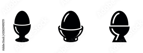 Foto Egg cups holding eggs in various styles and orientations.