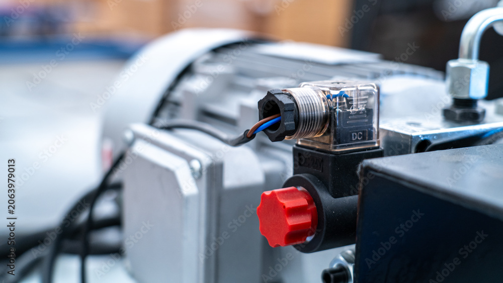 Fototapeta premium Electrical solenoid valve connecting to industrial hydraulic pump in factory