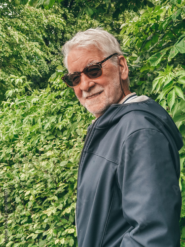 Fotografie Senior man smiling outdoors wearing sunglasses enjoying retirement and healthy l