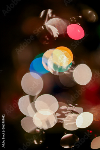 Colorful bokeh lights on a dark background creating an abstract festive effect.