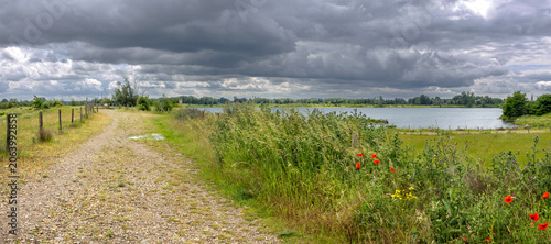 Thunderstorm over Negenoord protected area along the Meuse river near Dilsen-Stokkem, Belgium, designed for water storage and nature restoration