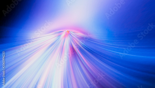 Abstract dynamic background with vibrant blue and pink light streaks radiating outward.