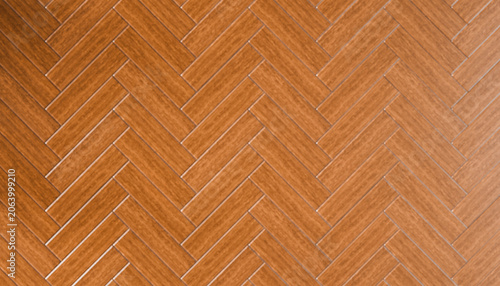 Herringbone patterned wooden floor with a warm, rich brown tone and smooth finish.