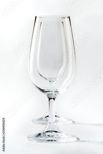 Two clear wine glasses nested together against a white background.