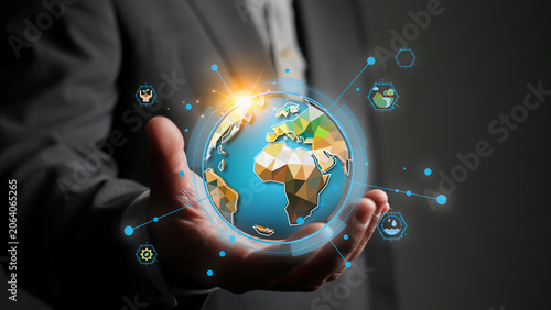 Businessman's hand holding a digital globe with sustainability icons for World Environment Day, representing global ecology awareness, green technology and environmental protection concept