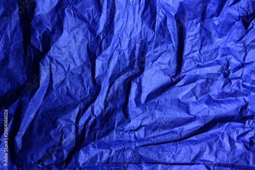 Crumpled paper texture in trendy luminous blue, wrinkled electric cobalt background for abstract modern design