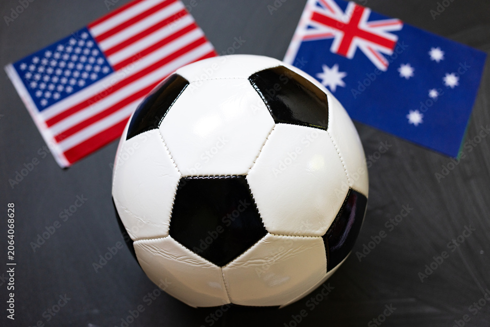 Fototapeta premium usa and Australia flags behind soccer ball