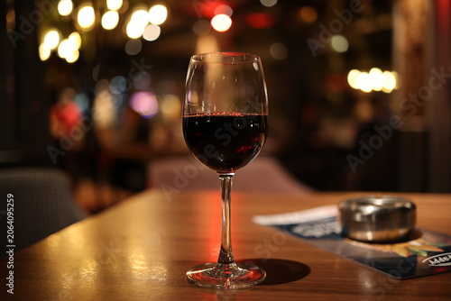 Fotografie A glass of drink, perhaps red wine for tonight?