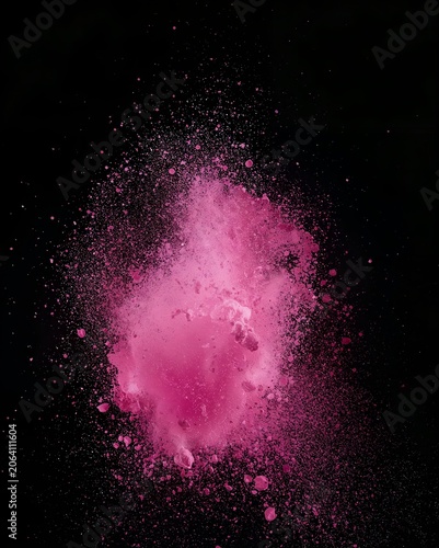 A vibrant pink powder explosion against a stark black background, creating a dynamic and artistic burst of color