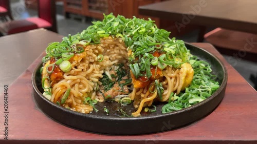日本のお好み焼き。青ネギと焼きそば麺がたっぷり入った広島県のお好み焼き。湯気が出てる断面の動画。