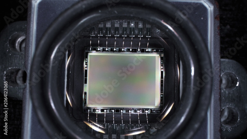 worker disassembled action camera to replace matrix on board microcircuit