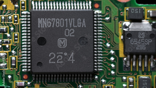 classic green motherboard with chipsets, memory modules, transistors and contacts