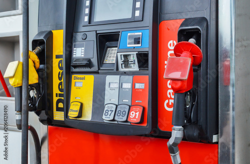 Close-up of a modern gas station fuel pump with gasoline and diesel nozzles.