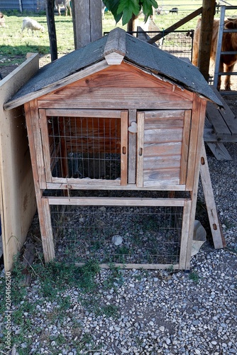 Wooden Animal Hutch on Gravel at Farm.