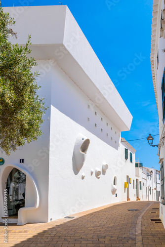Bild auf Leinwand Whitewashed street with an unusual modern house in the historic fishing village