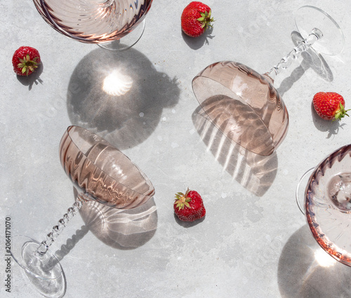 Strawberries and wine glasses on a light background