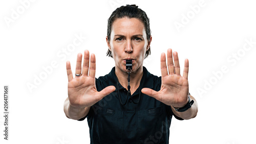 White male referee blowing whistle and showing stop sign with both hands. Middle aged adult man in official uniform looking at camera on transparent background. Concept of sports rule, and authority.