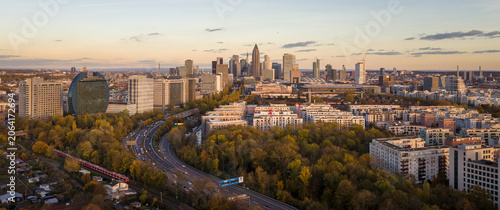 The modern city skyline of Frankfurt am main with greenery and transportation network at sunset