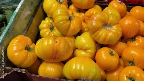 Green Crate Full Of Ripe Yellow Ribbed Heirloom Tomatoes For Sale Produce